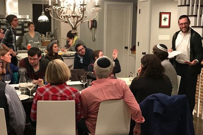 Worshippers gather to get acquainted at a home of a member of the new-pastor-Prospect Heights Shul